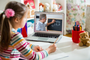 Photo of a girl hard at work during virtual teaching session