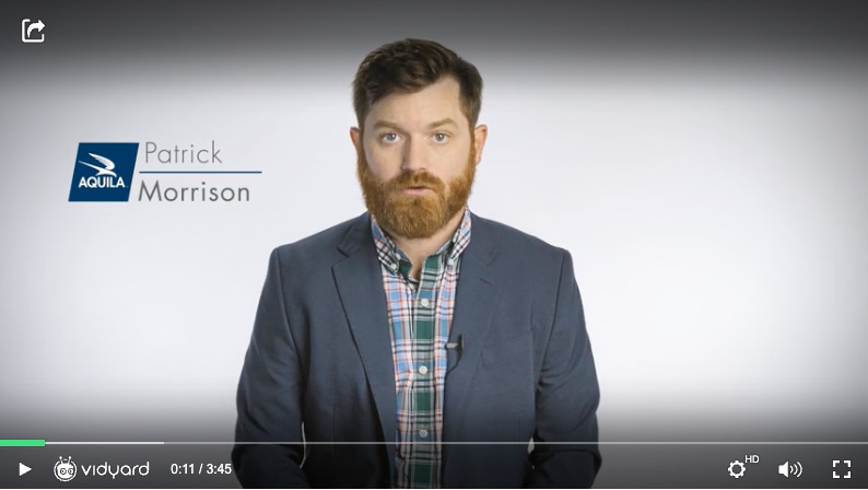 A screenshot of a simple FAQ video featuring a bearded businessman on a white background
