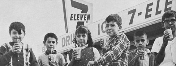 Children drinking fountain drinks outside of a 7Eleven store