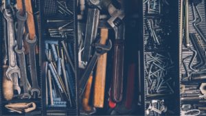 drawer full of tools, including wrenches and nails