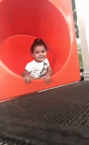 A GIF of a girl waving, then disappearing down a slide. Featured in Vidyard's Guide on How to Make a Gif