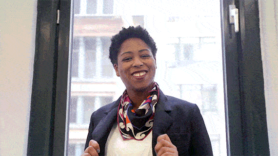 A GIF of a woman showing how to wear a scarf demonstrating how to use GIFs for social media marketing. 