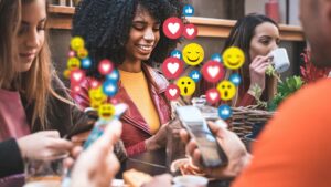 individuals at a coffee shop delight in social networks videos on their phones