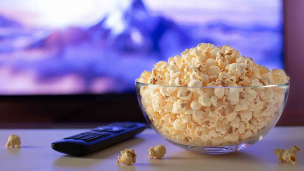 Popcorn and Remote Control in front of a tv screen