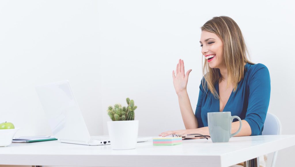 Woman recording video on a laptop