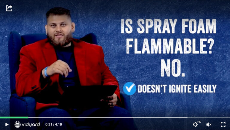 A screenshot of a video FAQ with a businessman in a bright red jacket and text on the background that reads "Is spray foam flammable?"